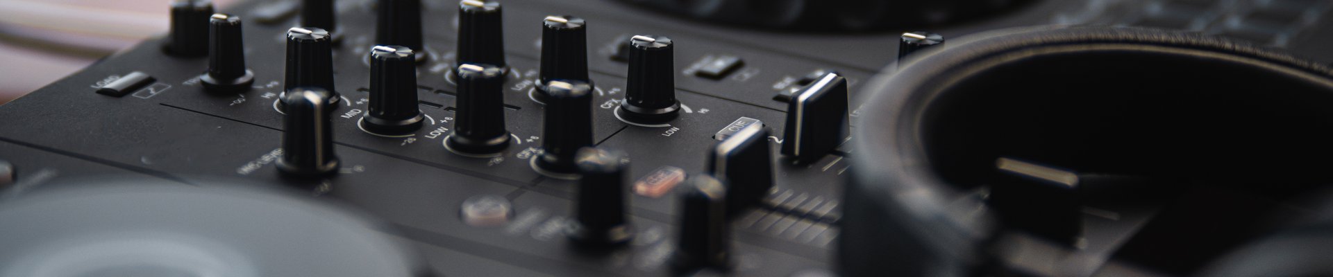 Close-up of DJ controller and mixing desk