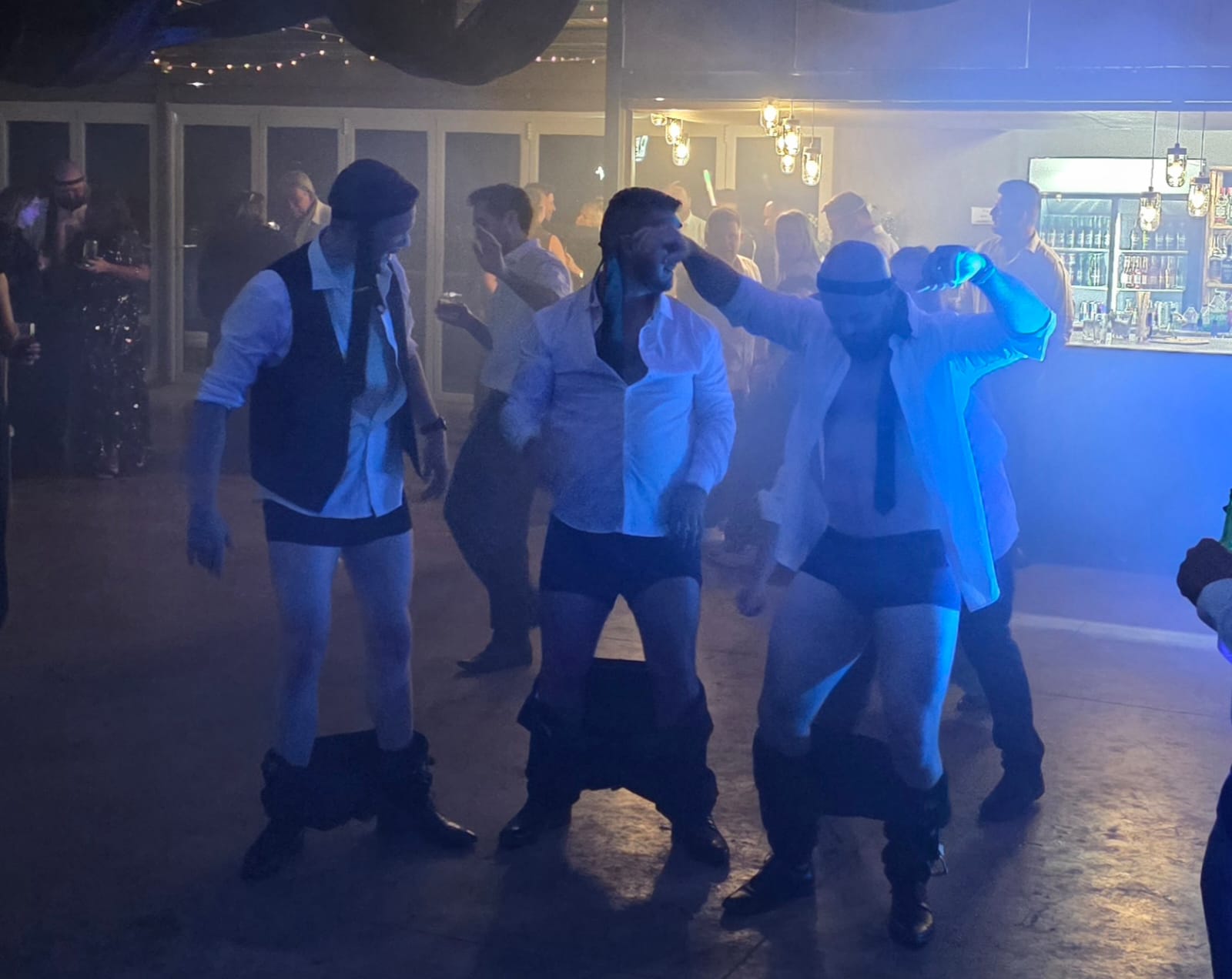 Blue uplighting on dance floor with guests dancing at Haycroft Farm wedding reception in Dargle Valley KZN