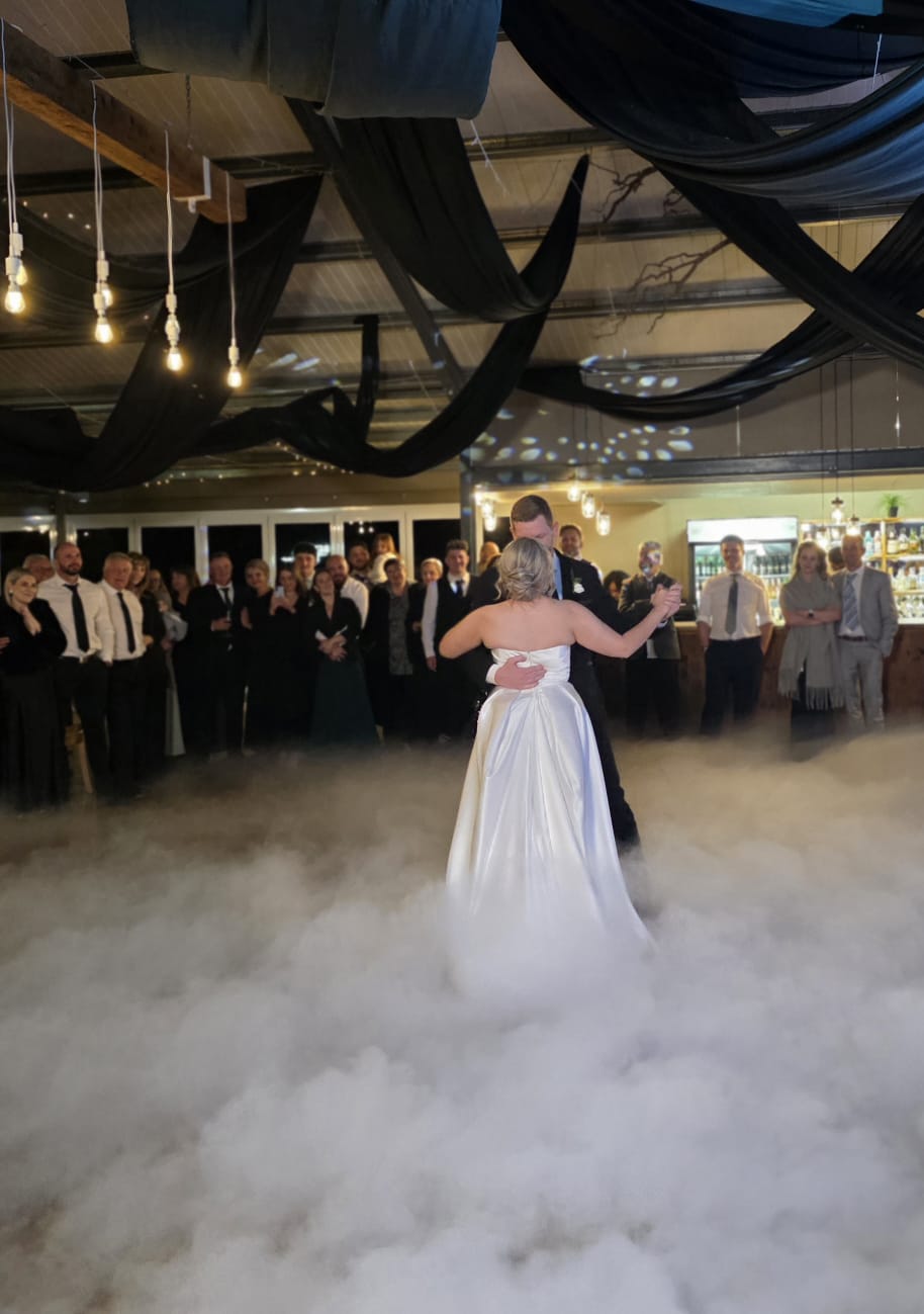 First dance with low fog effect and dramatic ceiling draping at Haycroft Farm wedding venue in Dargle Valley KZN Midlands