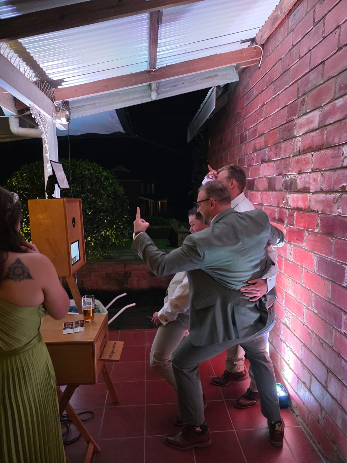 Photo booth side view showing wedding guests enjoying instant photo sessions at Providence venue