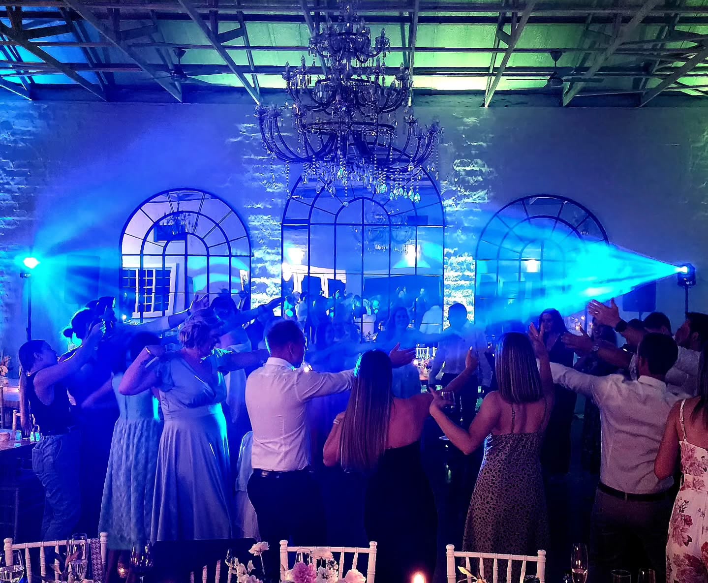 Wedding guests dancing at The Groves with professional DJ lighting in KZN Midlands