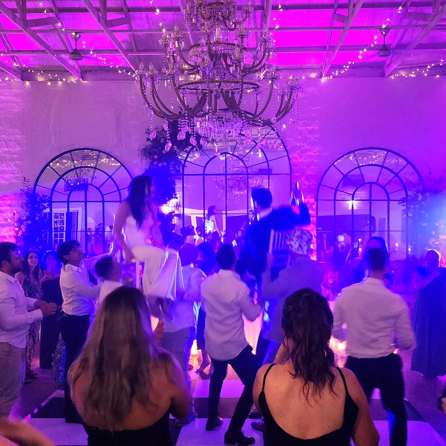 Guests enjoying dance floor with DJ lighting at The Groves wedding venue Caversham Valley